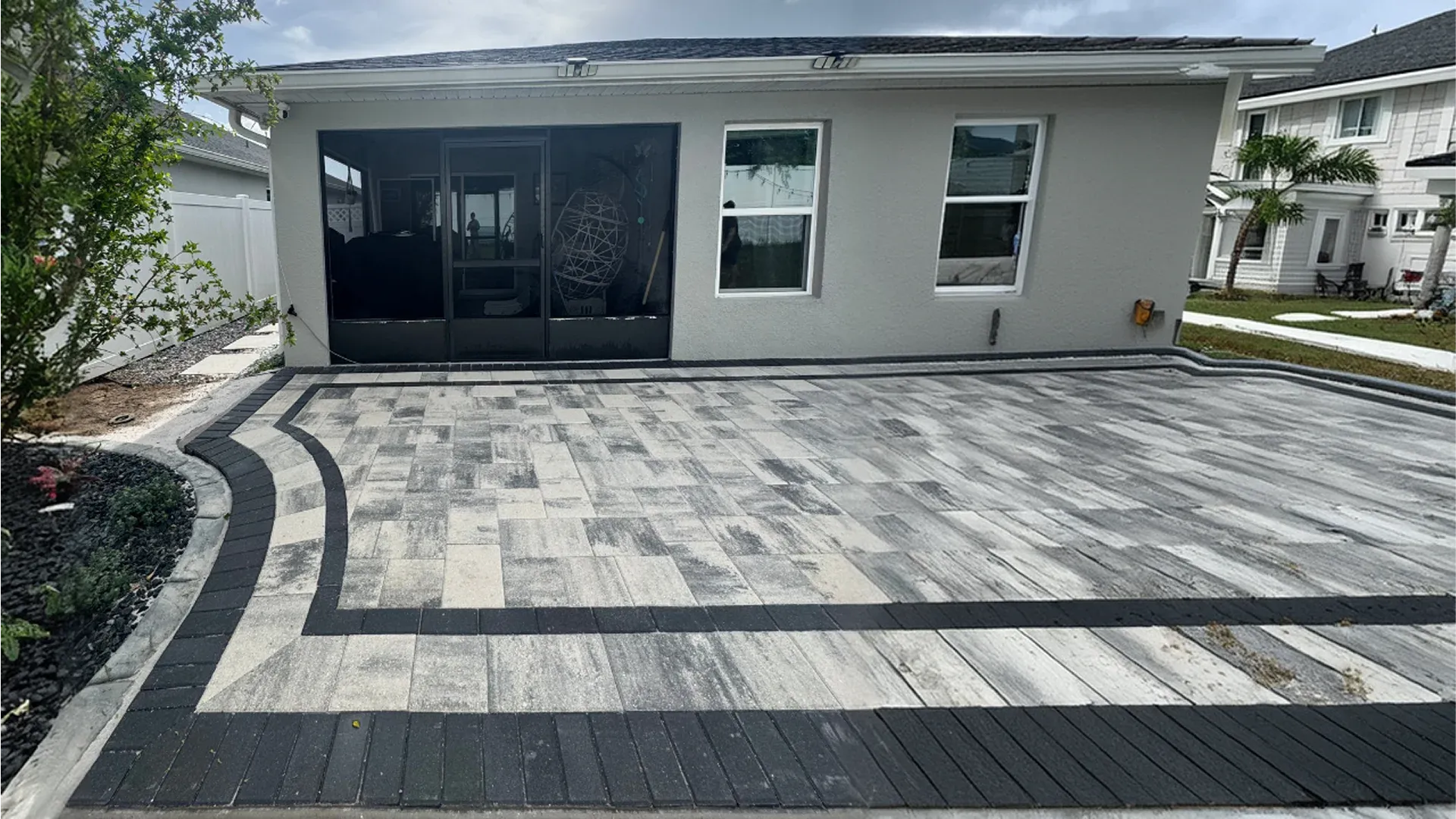 AllBrick Pavers large patio pavers project with dark border detail on Florida home