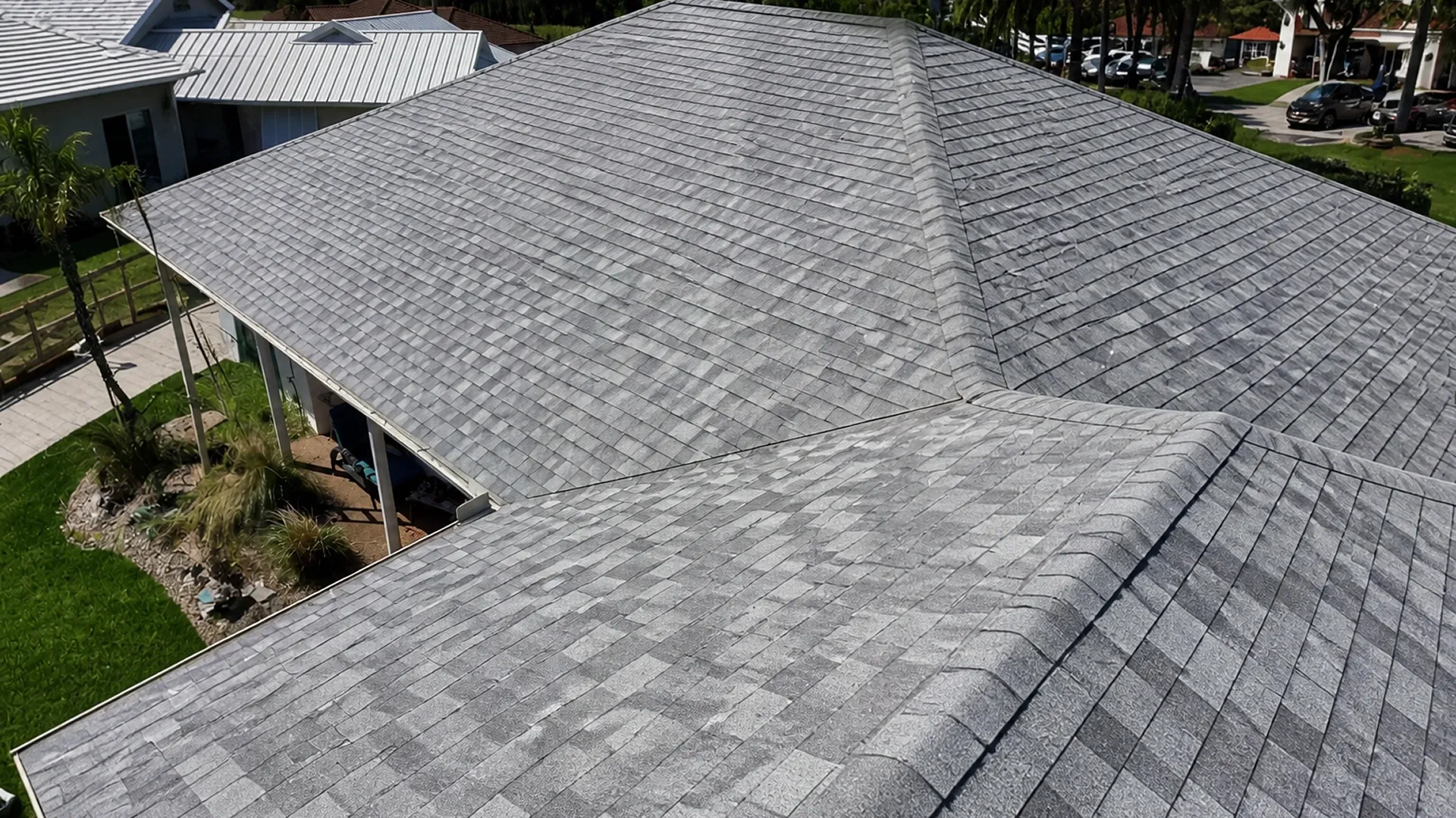 Aerial view of asphalt shingle roof construction on residential property Aerial view of asphalt shingle roof construction on residential property