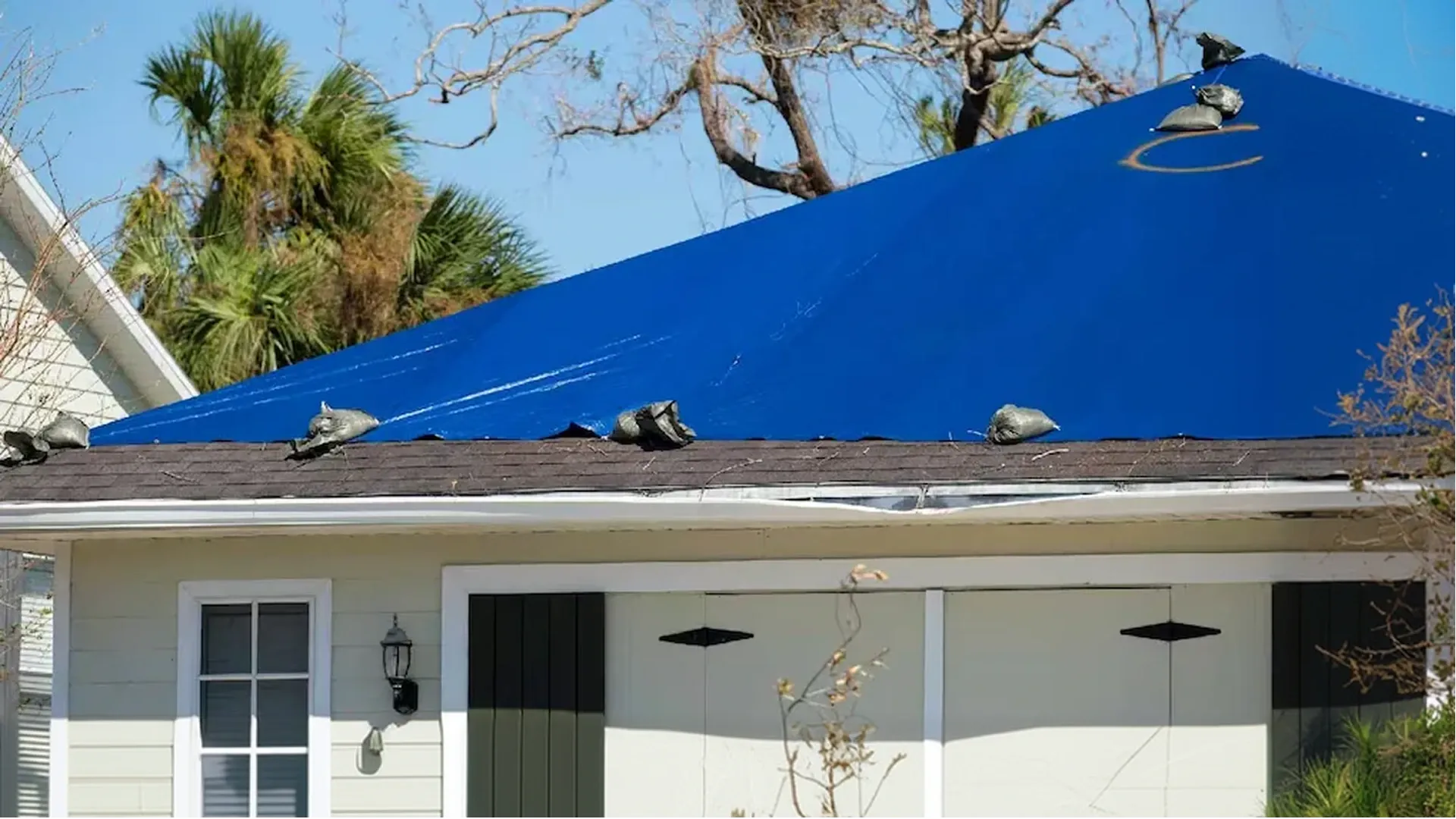 Temporary roof repair Tampa Bay Florida after storm damage with tarp installation Temporary roof repair Tampa Bay Florida after storm damage with tarp installation